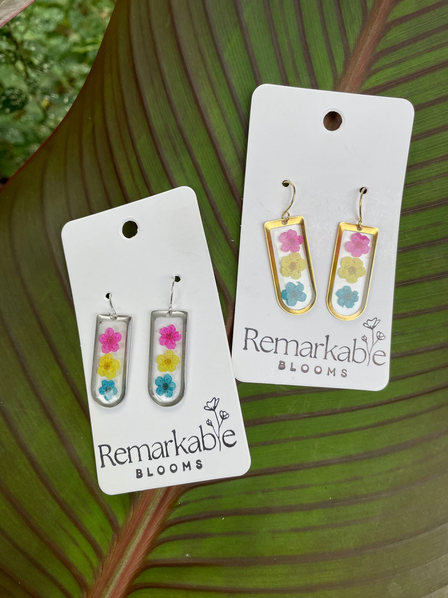 Handmade pink, yellow, and blue Real Pressed Flower Earrings. 14K White and Yellow Gold plated. Pride Earrings.