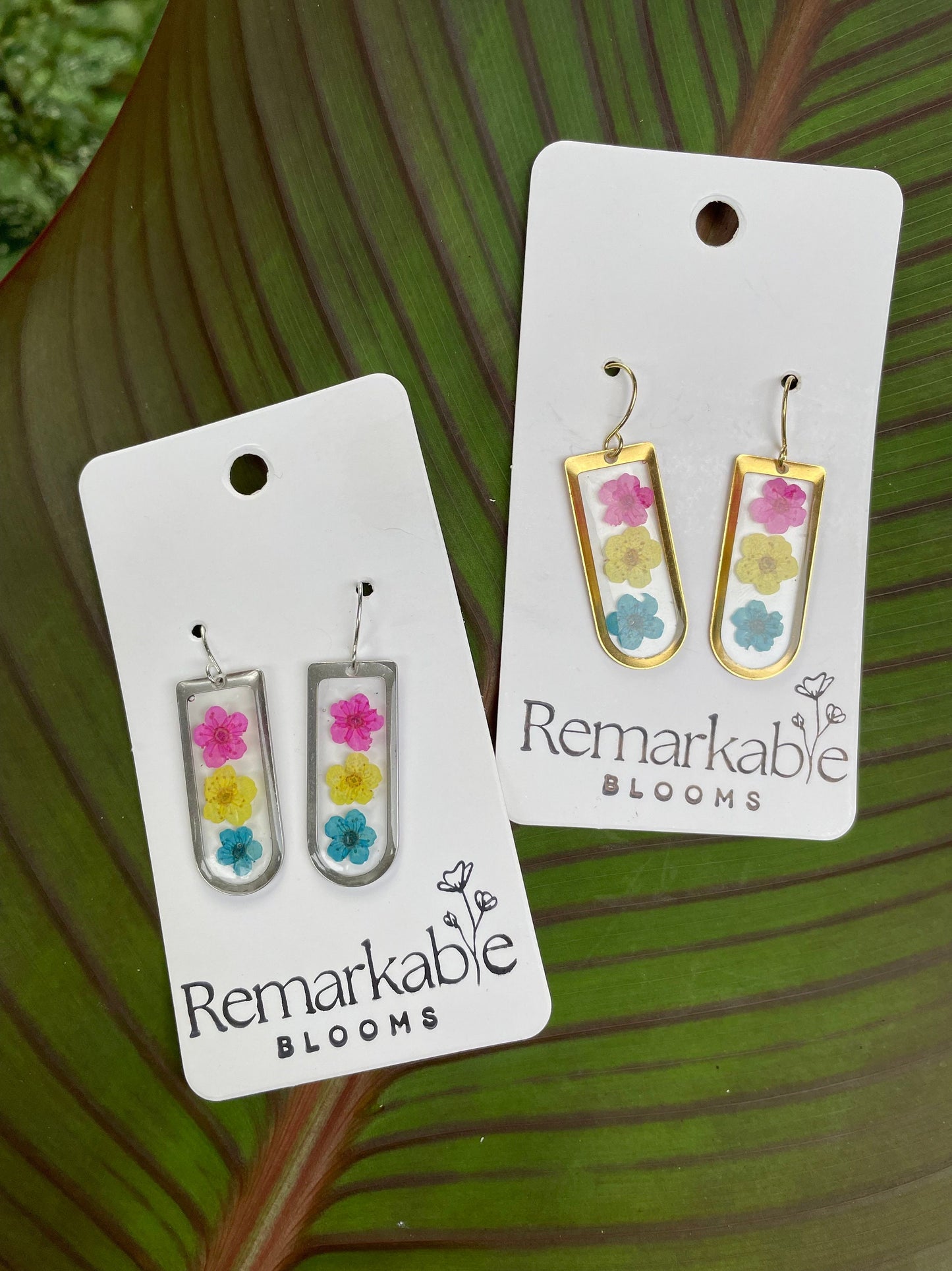 Handmade pink, yellow, and blue Real Pressed Flower Earrings. 14K White and Yellow Gold plated. Pride Earrings.